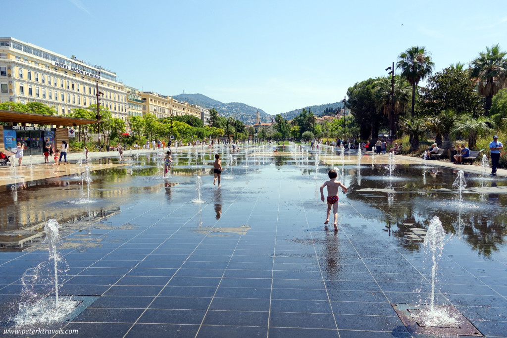 Children run in fountains near Place Massena