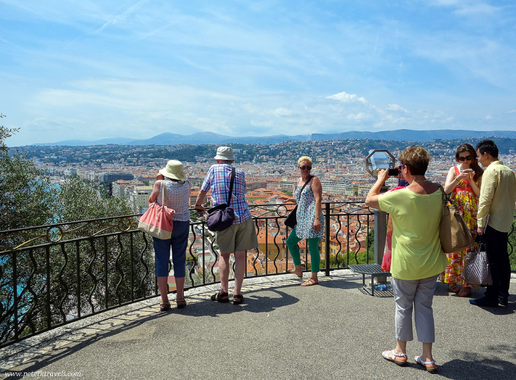 Tourists snap photos from the Colline du Chateau over look