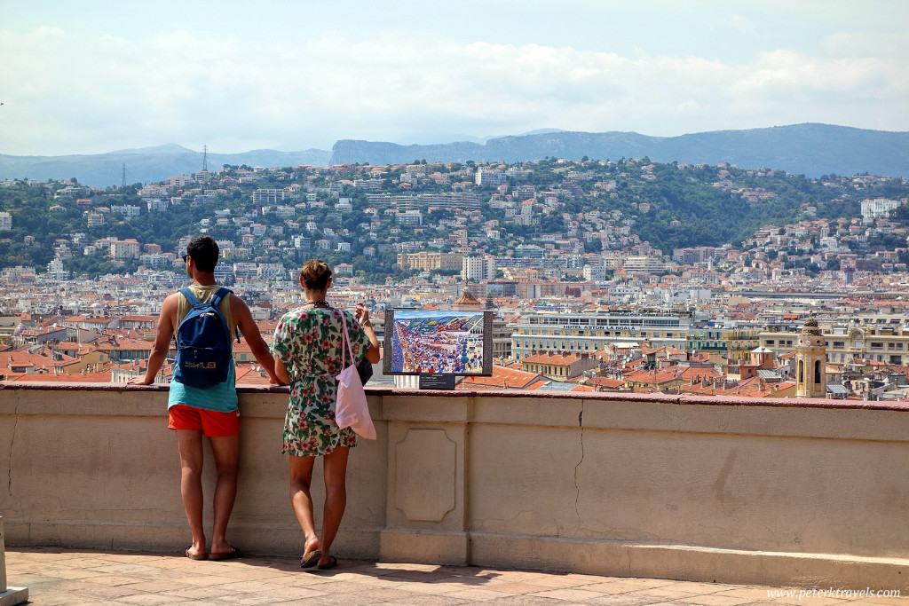 Tourists take in the view from one of the Colline du Chateau overlooks