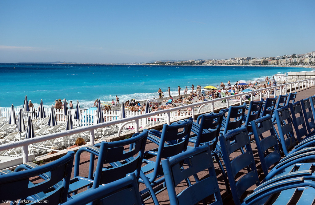 Blue chairs and beautiful water along Nice's Promenade des Anglais